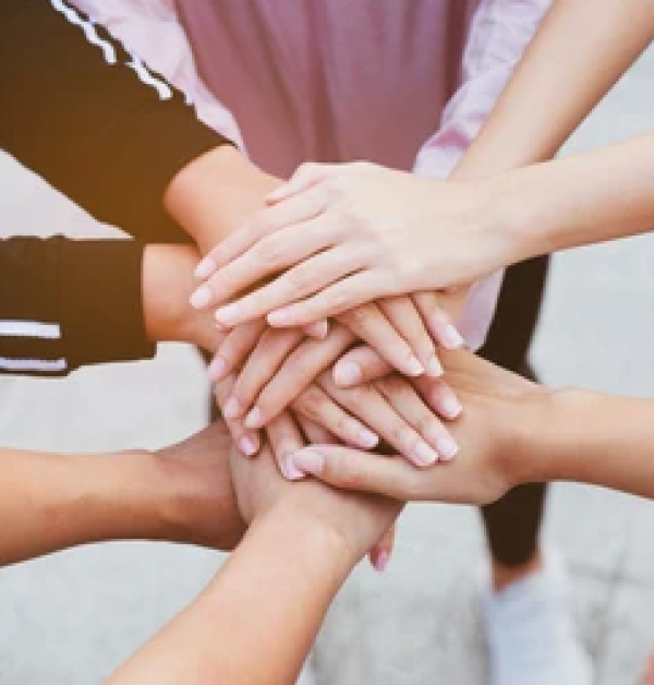 students holding hands together